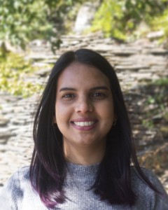 Azra Lari headshot, in front of nature scene