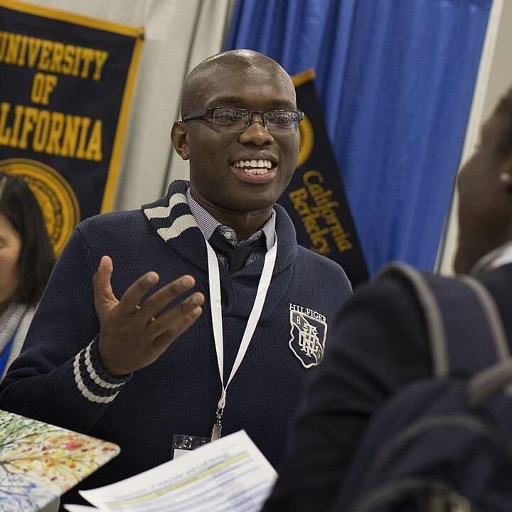 Picture of Chris Duncan-Lewis talking about science with other students at conference