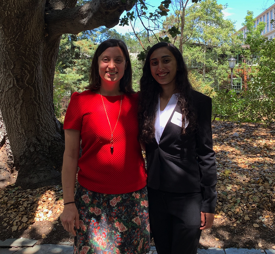 Picture of Ella Hartenian and Shivani Khosla standing in front of a garden